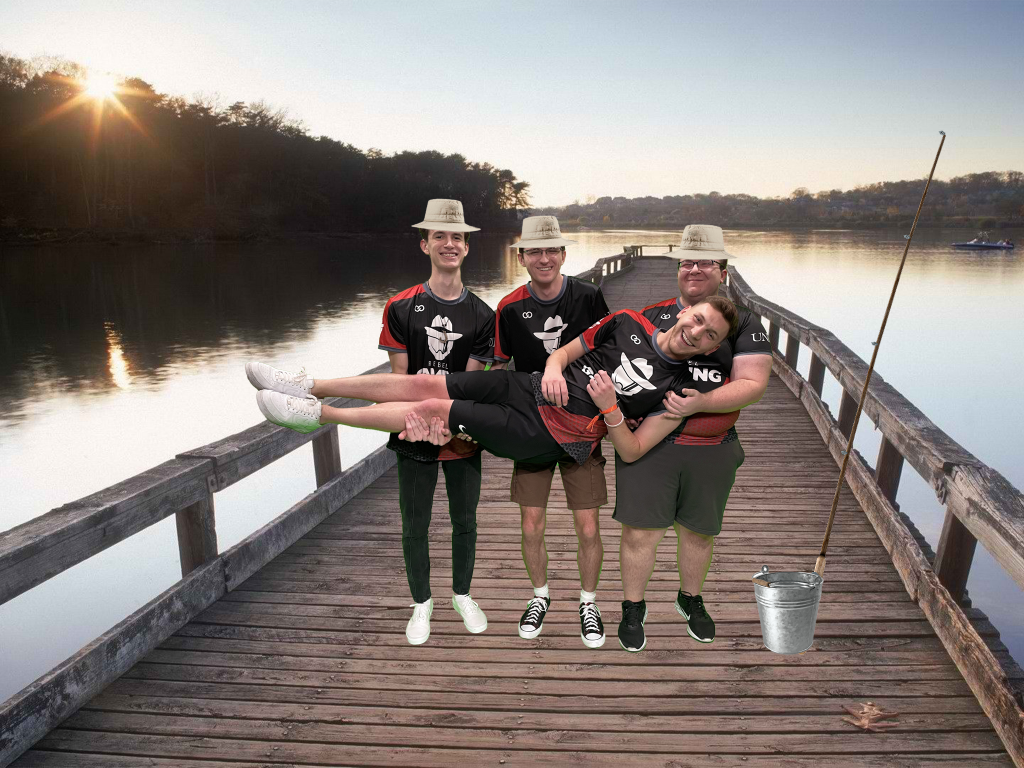 UNLV Rocket League team picture with Tuv, Nytro, and Garenn holding TheWheat as they stand on a pier. They are wearing bucket hates and there are fishing poles next to them.